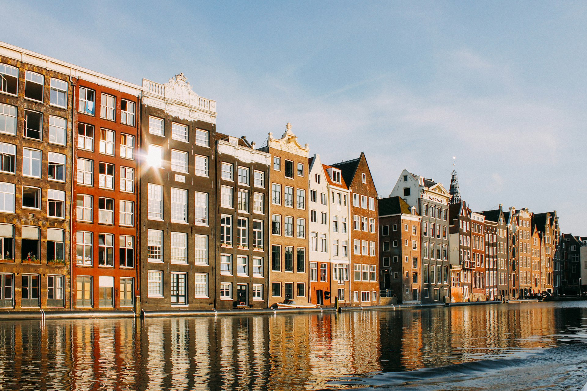 Amsterdamse grachtenpanden in gouden avondlicht